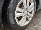 a close up of a car ' s tire on a wet road