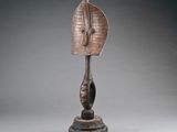 a bronze sculpture of a woman ' s head on a wooden base