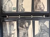 a black binder with a bunch of old photos on it