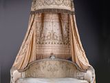 a bed that has a canopy over it in a room