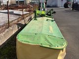 a large green and yellow boat sitting on the side of the road