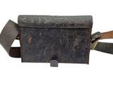 an old leather bag with a leather strap and a metal buckle