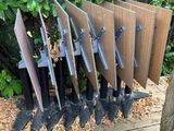 a wooden bench with a bunch of knives on top of it