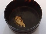 a bowl with a piece of food in it on a table
