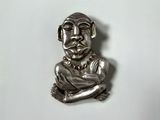 an image of a silver figurine of a man with his arms crossed