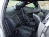 the interior of a car with black leather seats and a black seat belt