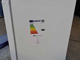 an image of a white refrigerator in a garage
