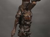 bronze statue of a woman holding a child on her lap