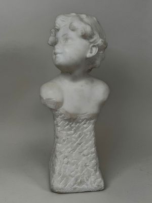 marble bust of a woman in a white dress on a gray background