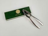 a pair of pliers sitting on top of a green box
