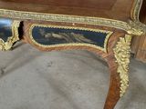 a wooden table with a black and gold design on it