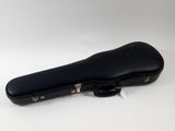 a close up of a black guitar case on a white surface