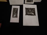 three framed pictures of a woman and a man on a black table
