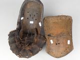 pair of old baseball mitts with tags on them on a white surface