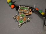 a close up of a necklace with beads on a table