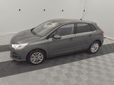 a picture of a small grey car parked in a garage