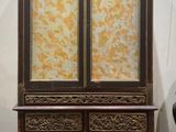 a wooden cabinet with a glass door on top of it