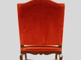 an orange chair sitting on top of a wooden table
