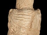 statue of a woman with a shawl on a black background