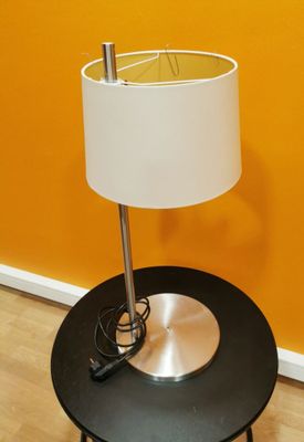 a black table with a white lamp on top of it