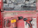 a red tool case with tools in it on the floor