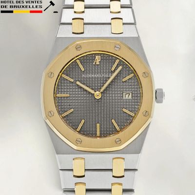 an image of a gold and silver watch with a black dial