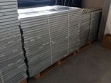 many stacks of steel plates stacked on pallets
