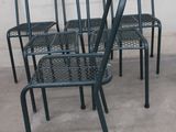 four chairs and a table on the concrete floor