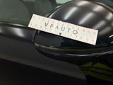 a sticker on the side mirror of a black car