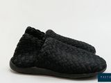 a picture of a pair of black slippers on a white background