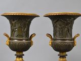 two vases that are sitting side by side on a table
