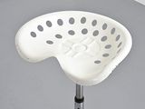 an image of a white stool on a gray floor