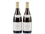 two bottles of wine sitting next to each other on a white surface