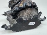 a statue of a woman sitting on top of a tree stump