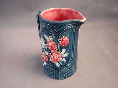 a blue vase with pink flowers on it