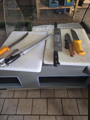 three knives on a cutting board on a table