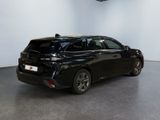 the back of a black car in a room with a white wall