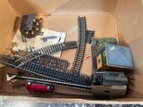 a box with a train set in it on the floor