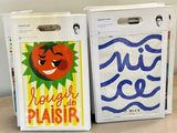 two boxes with different designs on them sitting on a table