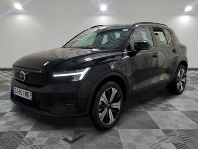 un SUV Volvo noir garé dans une pièce au sol carrelé