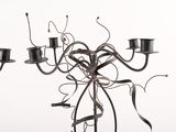 a metal candelab with a bunch of candles inside of it