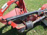 a red tractor that is sitting in the grass