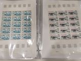 two envelopes with stamps on them sitting on a table