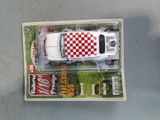 a toy truck with a checkered design in a box