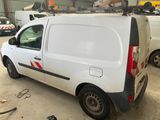 a white van parked in a garage with other vehicles