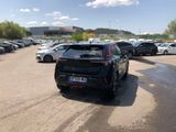 many cars parked in a parking lot with a sky background