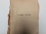 an old book with a piece of paper on top of it