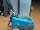 a close up of a machine on the ground in a garage