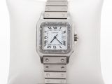 an image of a silver watch on a white pillow