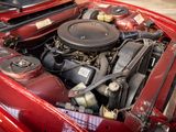 a red car with a engine in it ' s hood